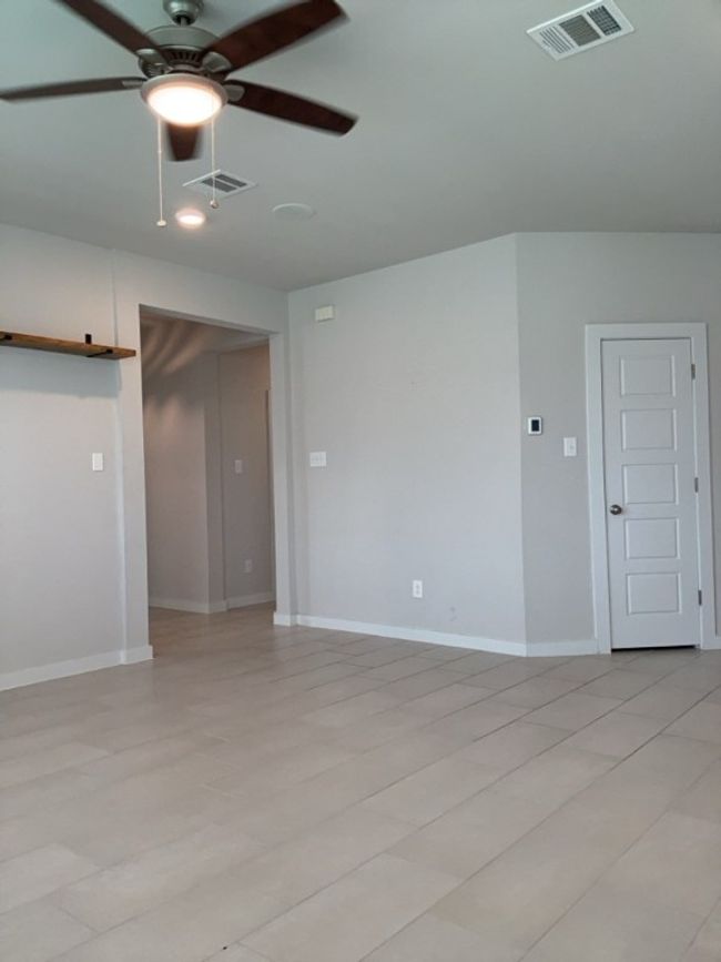 Living room with a ceiling fan and baseboards | Image 13