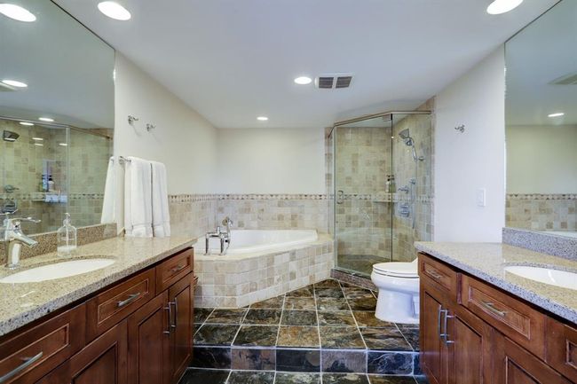 Remodeled Primary Bath. Two sinks, granite countertops, large shower and soaking tub. | Image 12