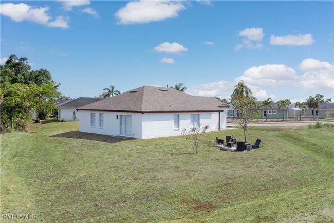 Rear view of house featuring a yard and stucco siding | Image 17