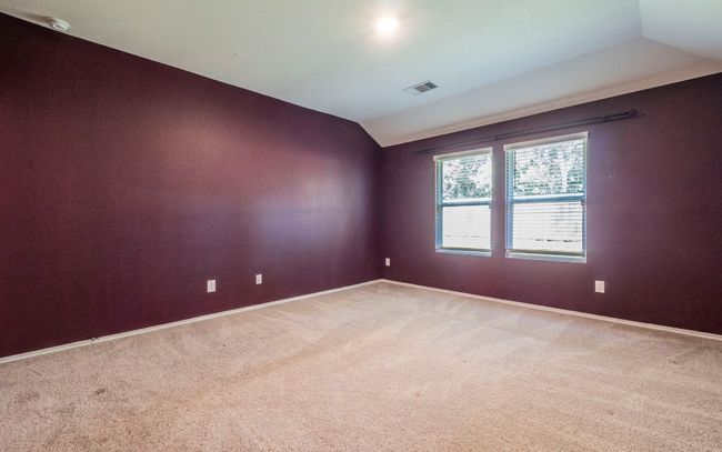 Empty room featuring vaulted ceiling and light colored carpet | Image 11