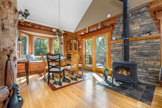 Dining room with wood burning stove & vaulted ceiling. | Image 4