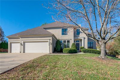 View of front property featuring a garage and a front lawn | Image 1