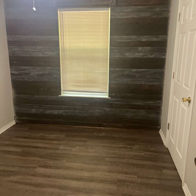 Bathroom featuring wood walls and dark wood-style flooring | Image 10