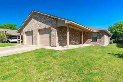 View of front of property with a garage, central AC, and a front lawn | Image 3