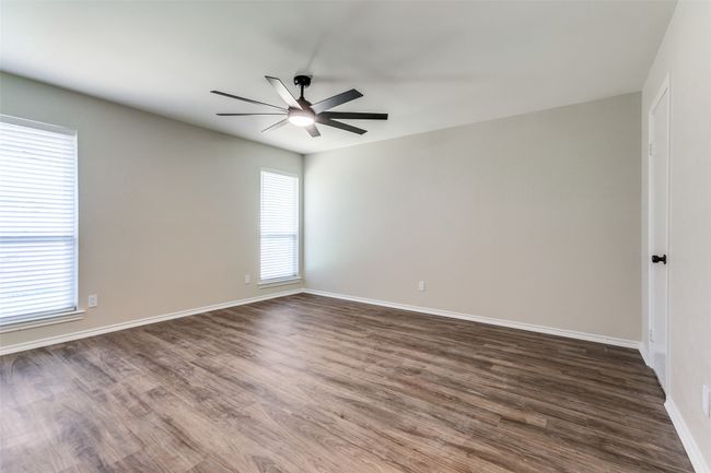 Empty room featuring a ceiling fan and dark wood finished floors | Image 19
