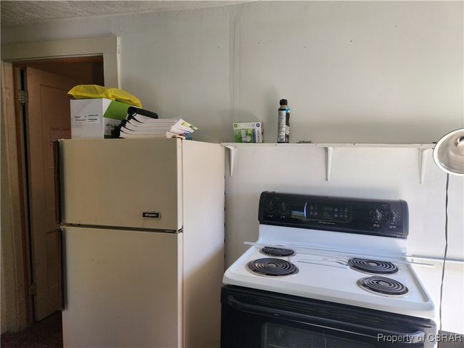 Upstairs kitchen/breakroom with stove, refrigerator, and sink. | Image 30