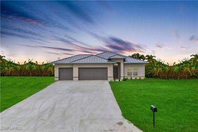 Curb appeal alert! Stunning semi custom home with METAL ROOF, elevated lot and and HURRICANE IMPACT windows and doors! | Image 1