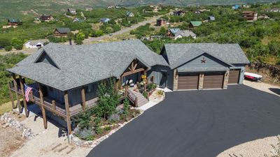 View of front of home featuring a porch and a garage | Image 1