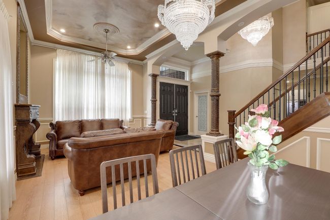 Dining area featuring light wood-type flooring, ornamental molding, a decorative wall, and ornate columns | Image 11