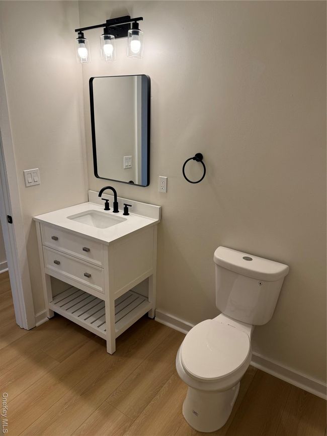 Bathroom with vanity and wood finished floors | Image 12