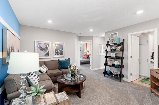 (Photo of a decorated model, actual homes finishes will vary) Located on the upper level, this perfectly sized living space has enough room for a desk, television and seating for all. Plus, it is just steps away from the three bedrooms. | Image 8