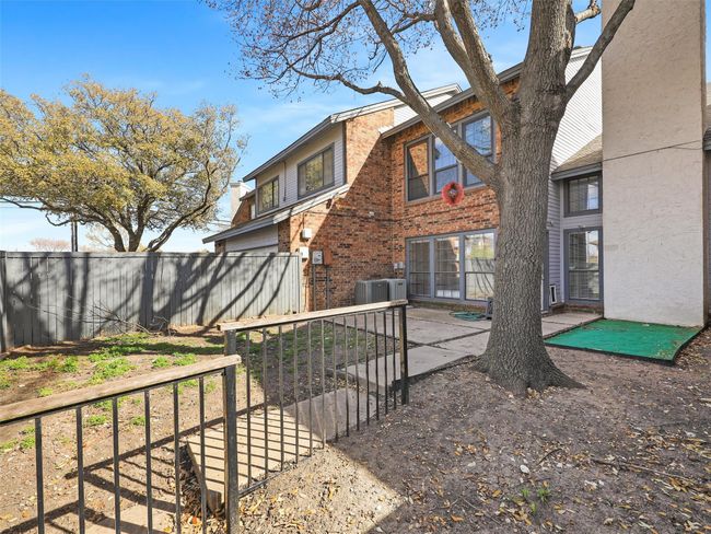 Rear view of house featuring a patio area, central air condition unit, brick siding, and fence | Image 33