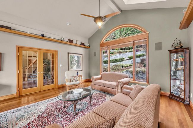 Living area with a skylight, french doors, a ceiling fan, and wood finished floors | Image 13