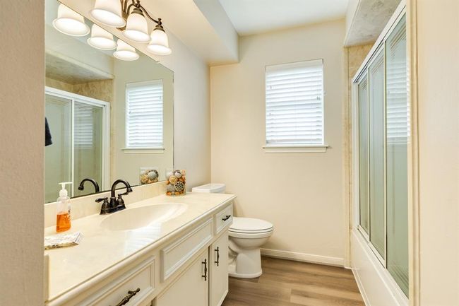 Full bath offers vanity, tub / shower combo and LVP flooring. | Image 26