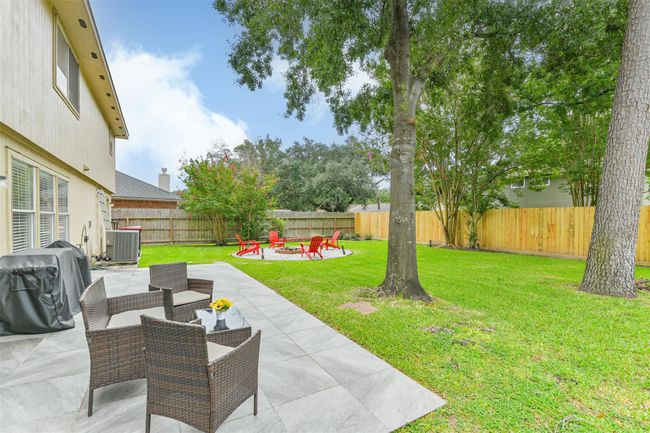 This large tiled patio area would easily fit a big outdoor dining table and grill area. | Image 24