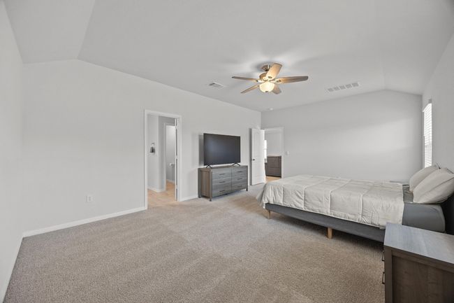 Primary bedroom with light colored carpet and a ceiling fan | Image 19