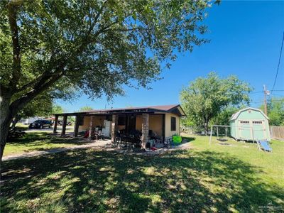 View of yard with a patio area and a storage shed | Image 2