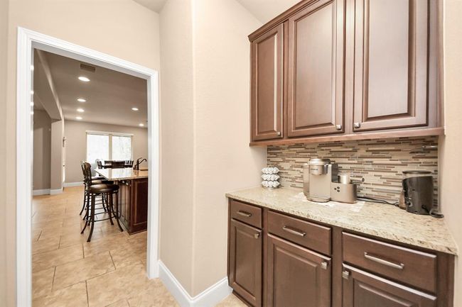 Connecting the Dining room to the kitchen, a Butler's pantry is an ideal space for a cute coffee and beverage bar. | Image 12