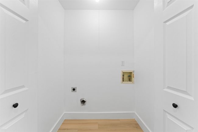 Laundry room featuring electric dryer hookup, washer hookup, and light wood-style flooring | Image 19