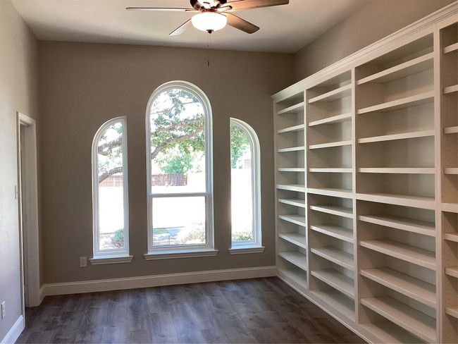 Unfurnished room with ceiling fan and dark wood-type flooring | Image 23