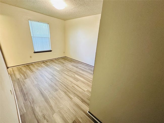 Unfurnished room featuring wood finished floors and a textured ceiling | Image 21
