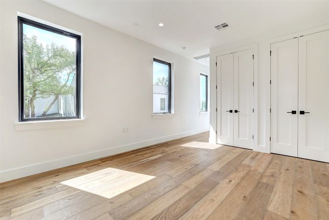 Unfurnished bedroom with two closets, light wood-type flooring, and recessed lighting | Image 19