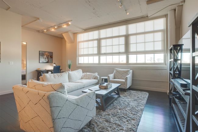 Living area featuring track lighting and dark wood-style floors | Image 17