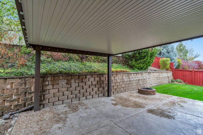 View of patio with a fire pit and a fenced backyard | Image 31