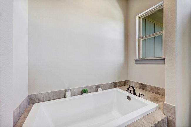 The primary bathroom has both a walk-in shower as well as a huge soaking tub. | Image 19