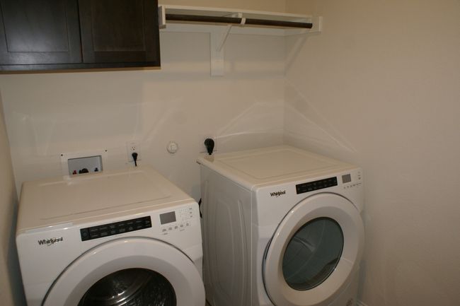 Utility room with cabinet space and separate washer and dryer | Image 8
