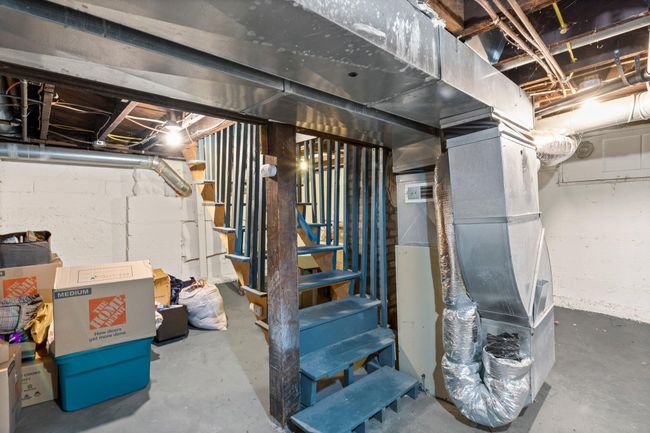 The unfinished basement, which includes the washer and dryer, also offers ample space for storage. | Image 11