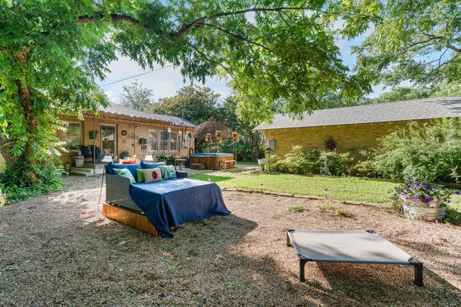 View of yard with a hot tub, a patio area, and an outdoor hangout area | Image 33