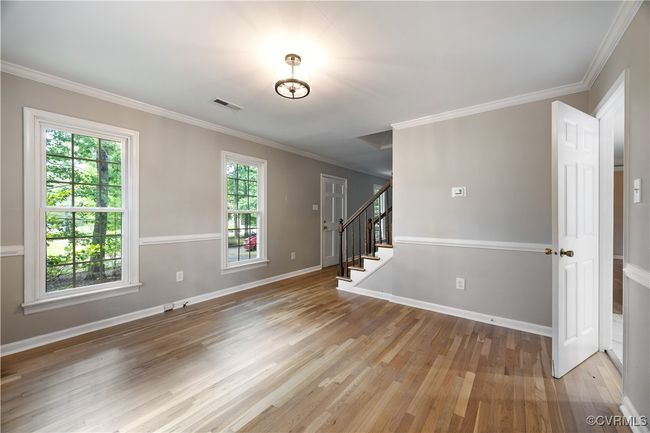 Dining room with hardwood floors, stairway, and crown molding | Image 8