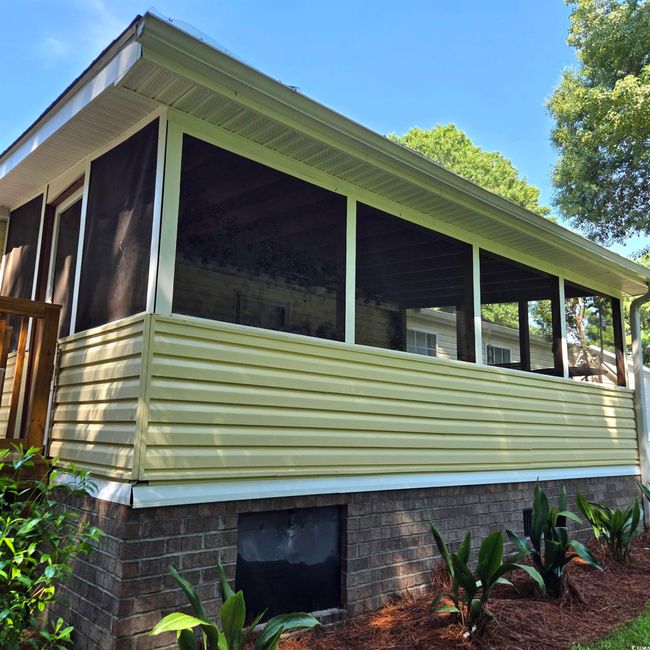 View of home's exterior with a sunroom | Image 34