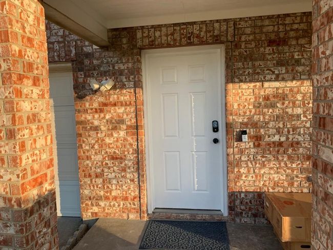 View of exterior entry featuring brick siding | Image 12