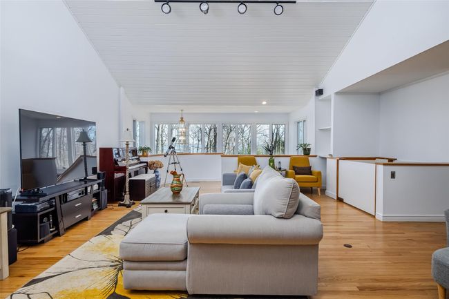 Living room with a wealth of natural light, baseboards, and light wood-style floors | Image 7