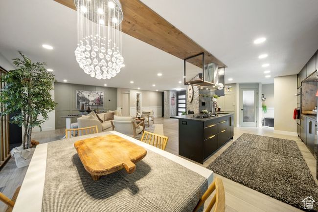 Dining area with a decorative wall, recessed lighting, a chandelier, and light wood finished floors | Image 5