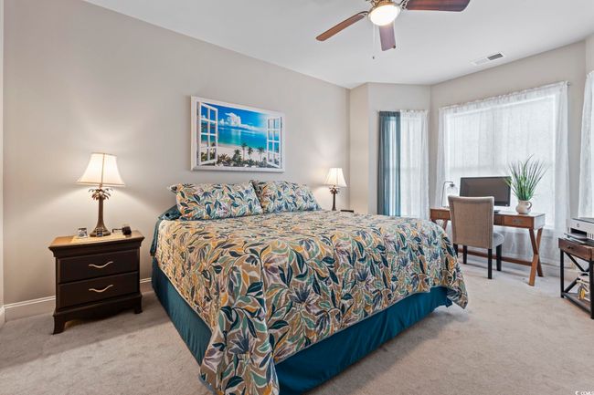 Bedroom with carpet flooring and ceiling fan | Image 5