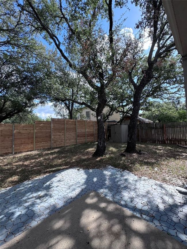 Fenced backyard featuring a patio area and a storage unit | Image 28