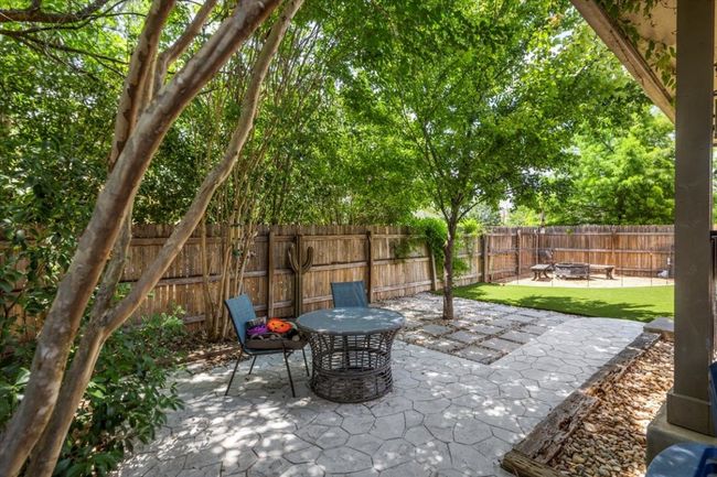 Fenced backyard with a patio | Image 33