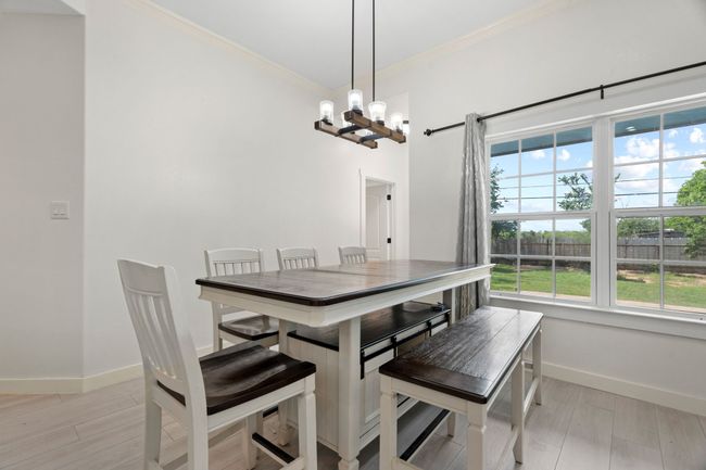 Dining area with a chandelier, ornamental molding, and light wood-type flooring | Image 10