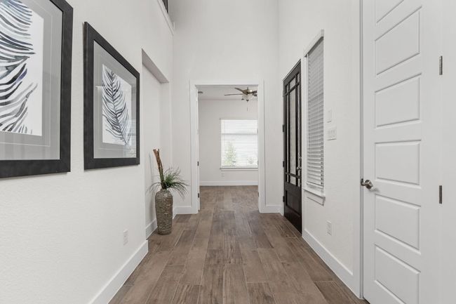 Hall featuring dark wood-type flooring and baseboards | Image 6