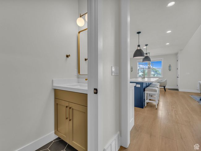 Bathroom featuring vanity, recessed lighting, baseboards, and wood finished floors | Image 20