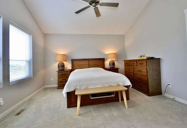 Bedroom featuring lofted ceiling, light carpet, and a ceiling fan | Image 27