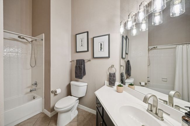 The secondary full bath features updated lighting, generous counter space, and neutral tones that blend seamlessly with the rest of the home’s modern finishes. | Image 26