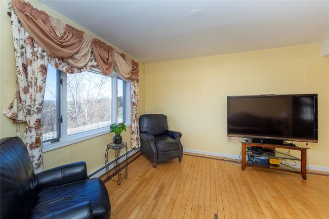 Living Room featuring baseboard heating, baseboards, and hardwood / wood-style flooring | Image 17