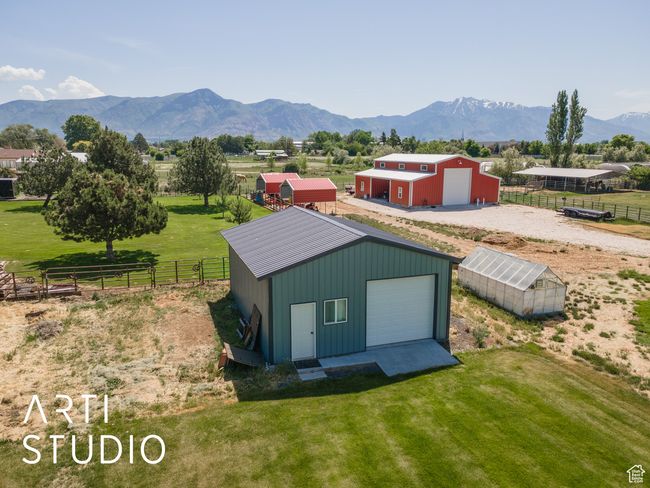 View of pole building featuring a mountain view, an exterior structure, and a view of rural / pastoral area | Image 46