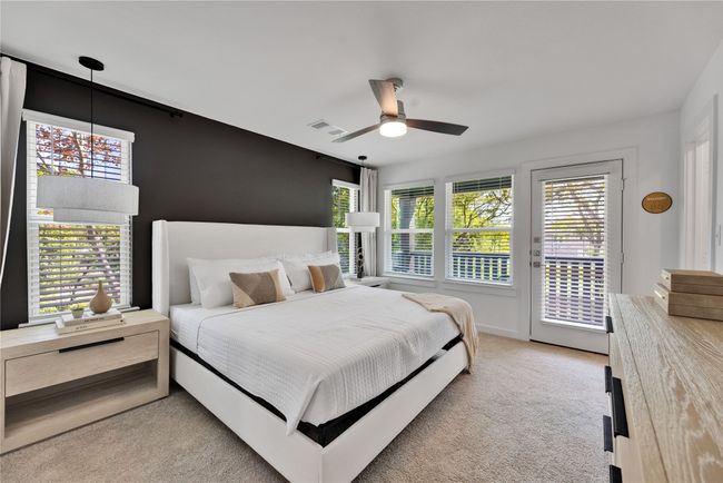 Bedroom with access to exterior, light colored carpet, multiple windows, and visible vents | Image 18