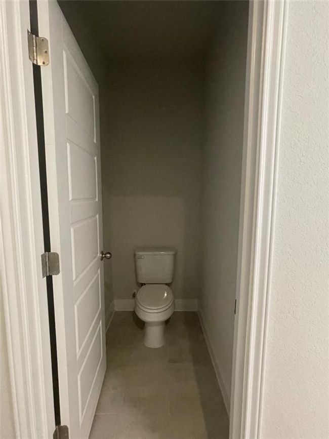 Bathroom featuring toilet and tile patterned flooring | Image 12