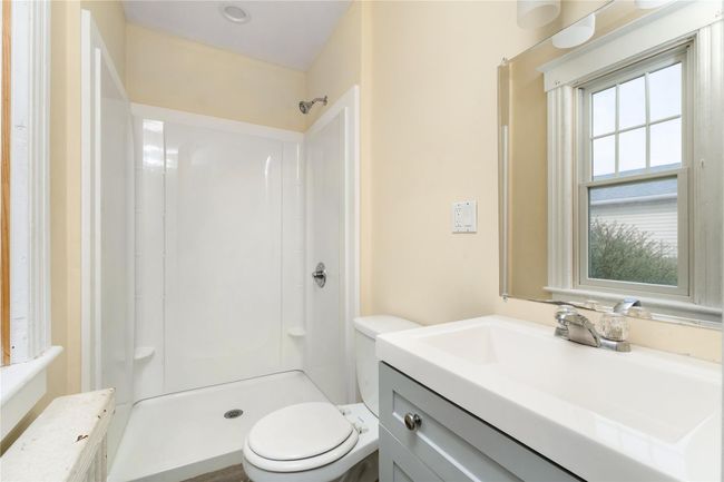 Bathroom with a shower stall, toilet, and vanity | Image 15